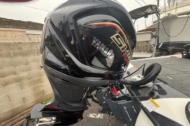 Slide: The Image of 2024 Skeeter FXR21 Limited with Yamaha outboard motor, parked outdoors. - 16