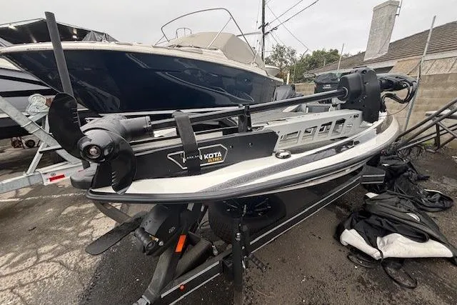 Slide: The Image of 2024 Skeeter FXR21 Limited boat with Minn Kota trolling motor, parked on a trailer. - 22