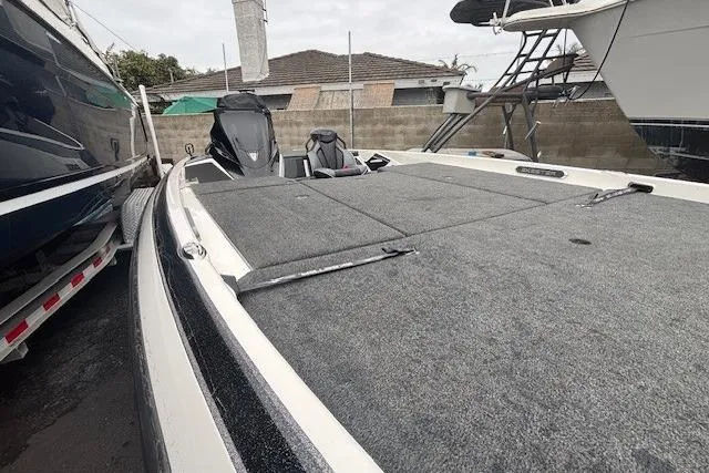 Slide: The Image of 2024 Skeeter FXR21 Limited boat with spacious deck, parked in a marina. - 4