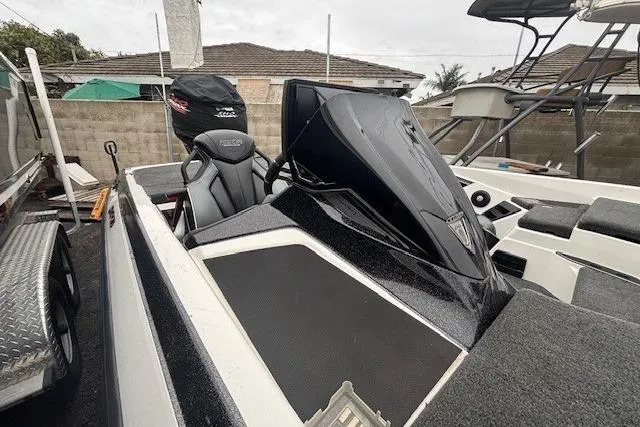 Slide: The Image of 2024 Skeeter FXR21 Limited boat with sleek design, parked on a trailer. - 8