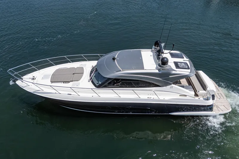 Slide: The Image of 2021 Riviera 4800 Sport Yacht cruising on calm waters, showcasing sleek design and luxury features. - 10
