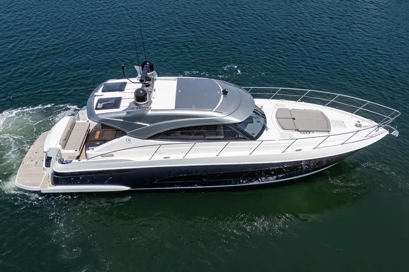 Slide: The Image of 2021 Riviera 4800 Sport Yacht cruising on open water, showcasing sleek design and luxury features. - 11