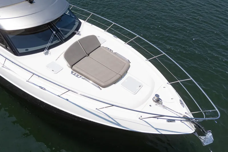 Slide: The Image of 2021 Riviera 4800 Sport Yacht with sunbed on deck, cruising on water. - 15