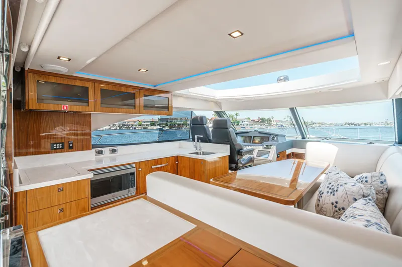 Slide: The Image of Luxurious interior of 2021 Riviera 4800 Sport Yacht with modern kitchen and seating area. - 34