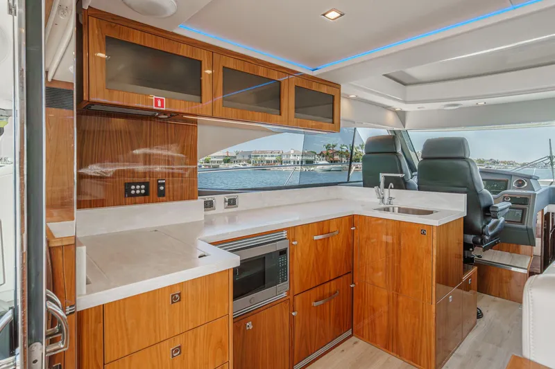 Slide: The Image of Luxurious interior of 2021 Riviera 4800 Sport Yacht with modern kitchen and helm. - 36