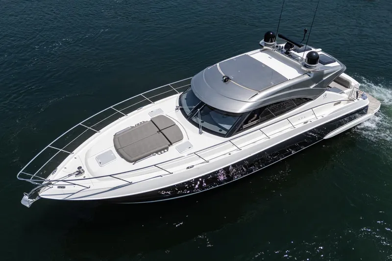 Slide: The Image of 2021 Riviera 4800 Sport Yacht cruising on open water, aerial view. - 4