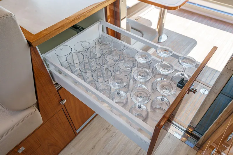 Slide: The Image of Open drawer with wine glasses on 2021 Riviera 4800 Sport Yacht. - 40