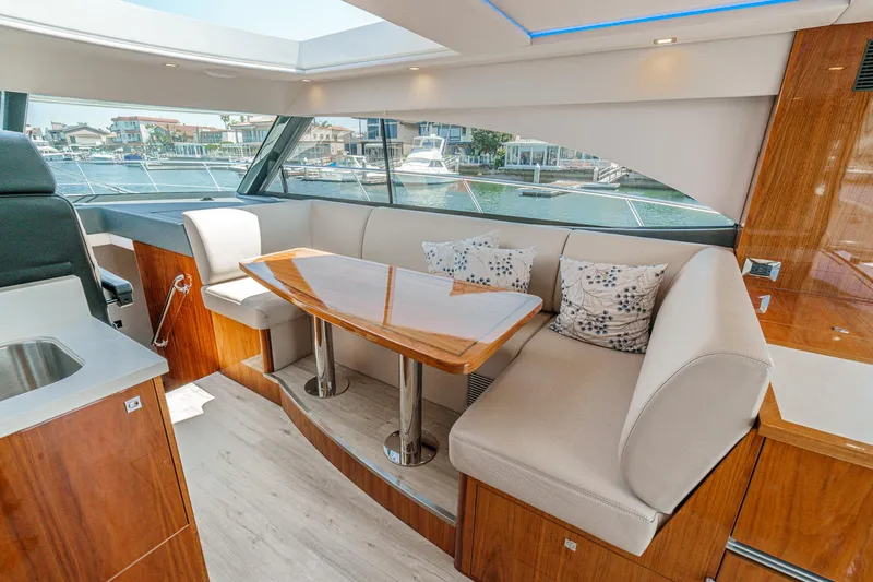 Slide: The Image of Luxurious interior of 2021 Riviera 4800 Sport Yacht with elegant seating and table. - 41