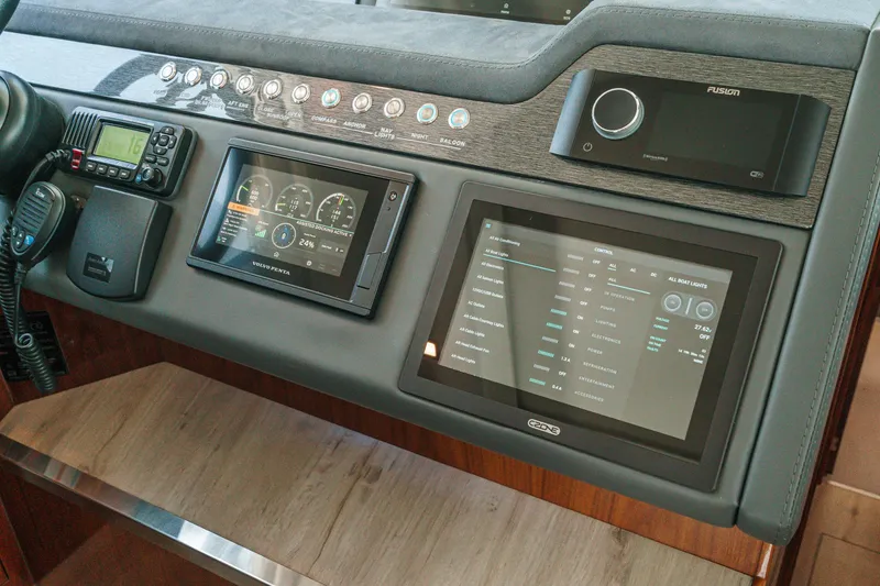 Slide: The Image of Control panel of 2021 Riviera 4800 Sport Yacht with digital displays and navigation equipment. - 49