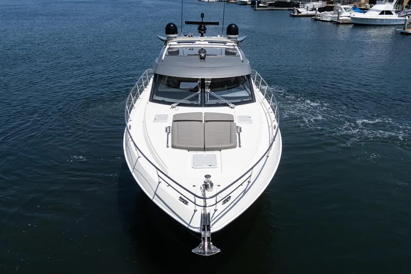 Slide: The Image of Riviera 4800 Sport Yacht 2021 cruising on calm waters, front view. - 5