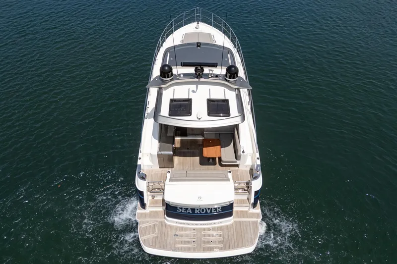 Slide: The Image of 2021 Riviera 4800 Sport Yacht cruising on open water, aerial view. - 8