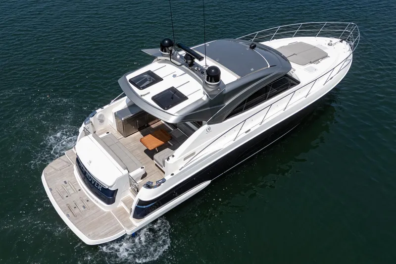 Slide: The Image of 2021 Riviera 4800 Sport Yacht cruising on open water, showcasing sleek design and luxury features. - 9