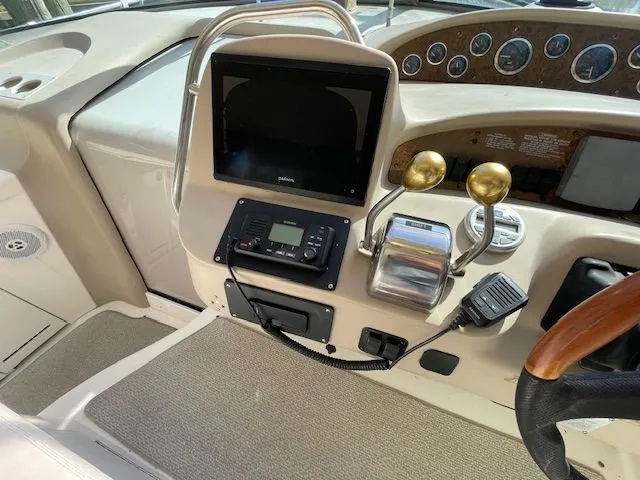 Slide: The Image of 2002 Sea Ray 340 Sundancer helm with navigation system. - 11