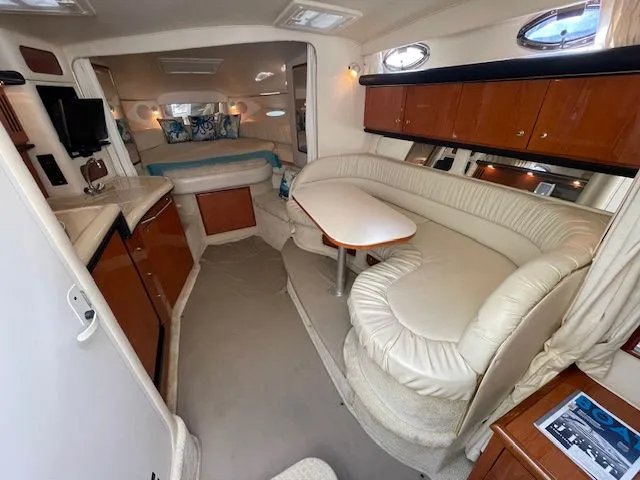 Slide: The Image of Interior of a 2002 Sea Ray 340 Sundancer yacht with elegant furnishings. - 12