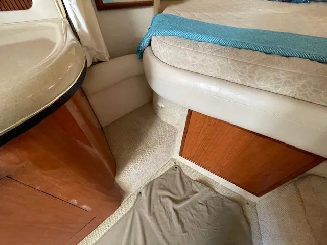 Slide: The Image of Interior of a 2002 Sea Ray 340 Sundancer yacht with bed and wooden cabinetry. - 27