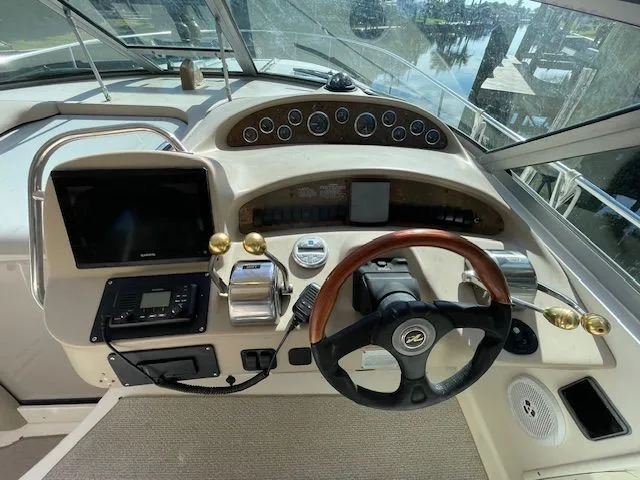 Slide: The Image of 2002 Sea Ray 340 Sundancer helm with wooden steering wheel. - 7
