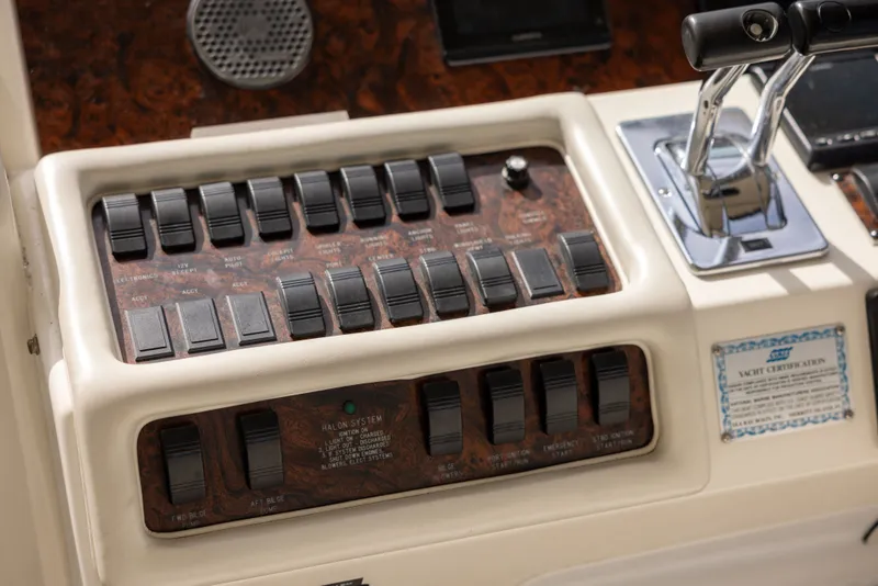 Slide: The Image of Dashboard of a 1997 Sea Ray 400 boat with switches and levers. - 11