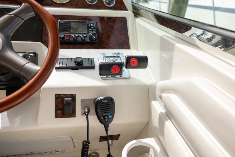 Slide: The Image of 1997 Sea Ray 400 yacht helm with controls and radio equipment. - 12