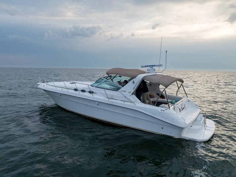 Slide: The Image of 1997 Sea Ray 400 yacht on calm sea at sunset. - 4
