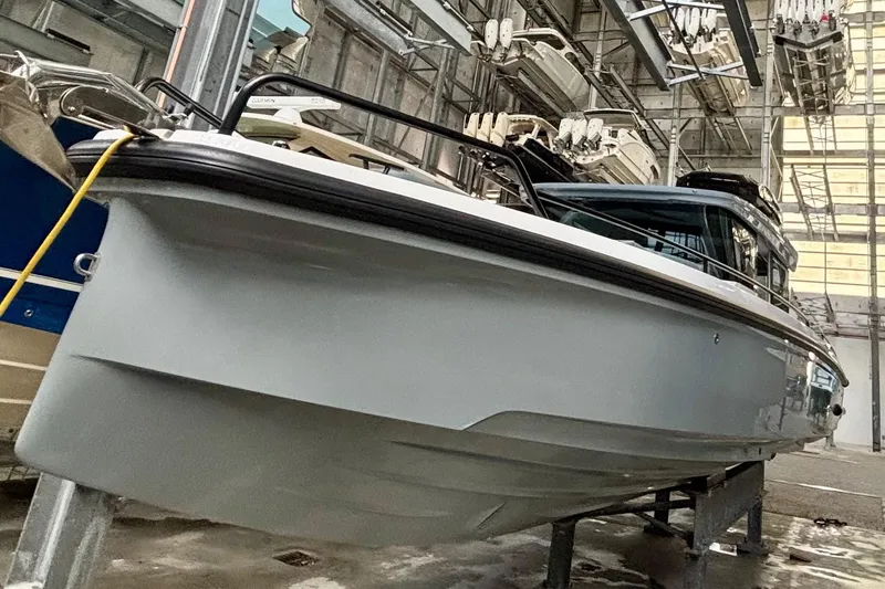 Slide: The Image of 2024 Axopar 37 XC Cross Cabin boat in storage, showcasing sleek design and modern features. - 14