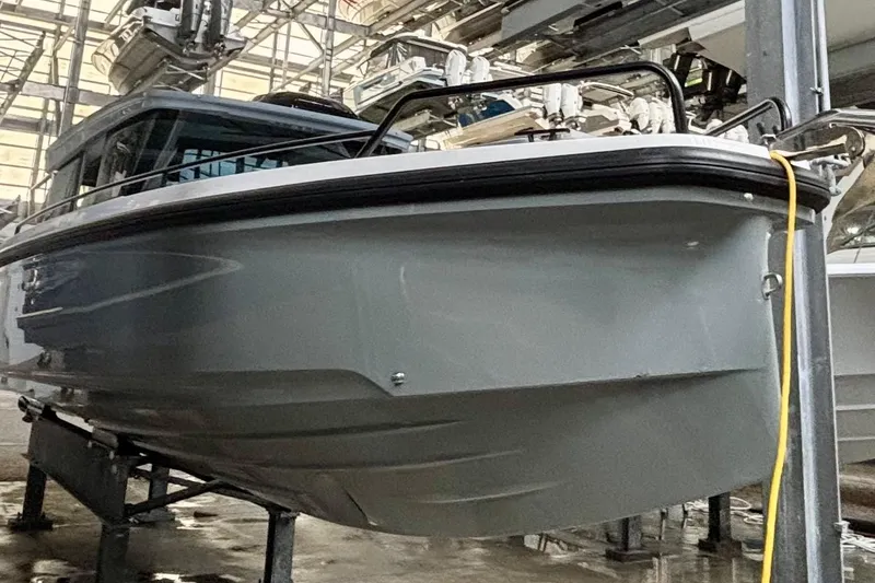 Slide: The Image of 2024 Axopar 37 XC Cross Cabin bow with quilted seating and sleek railings. - 15