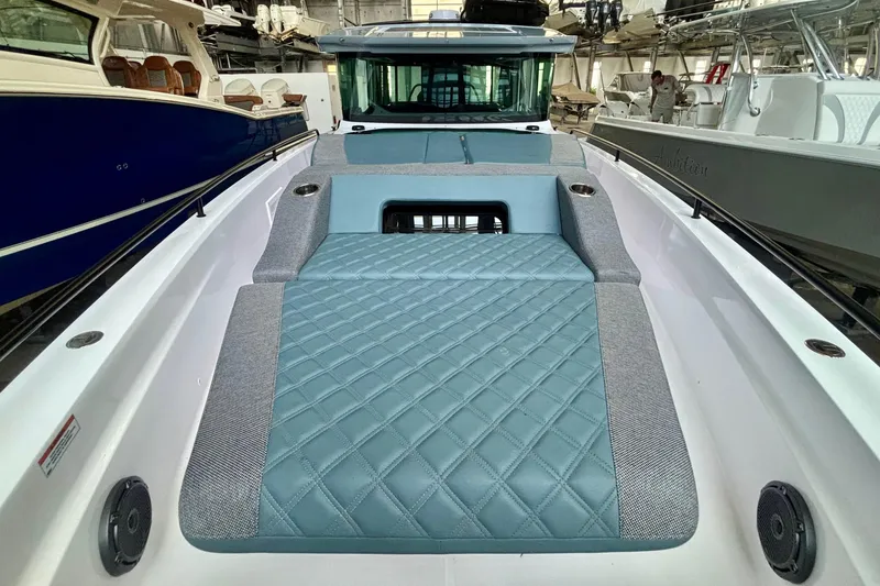 Slide: The Image of Luxurious seating on 2024 Axopar 37 XC Cross Cabin with diamond-pattern upholstery. - 17