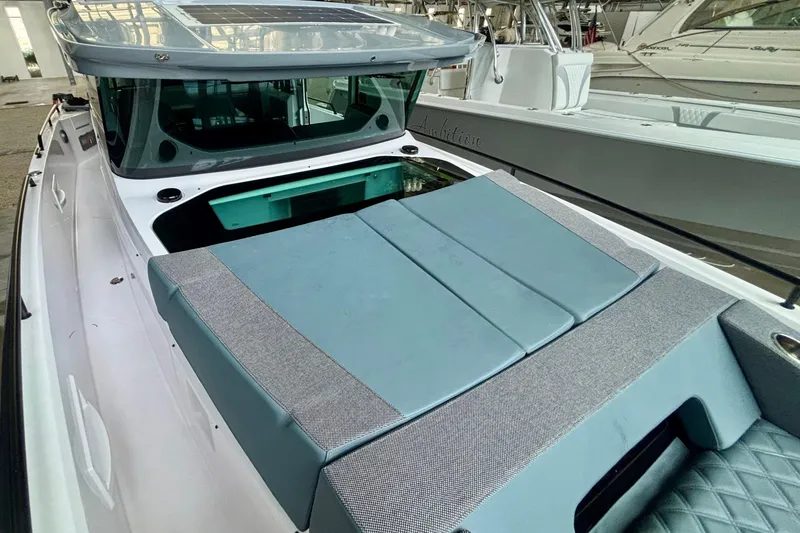 Slide: The Image of 2024 Axopar 37 XC Cross Cabin with solar panel on roof in a showroom. - 20