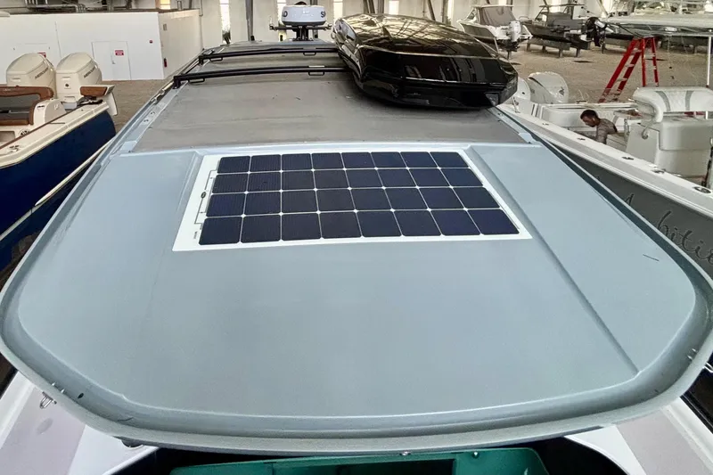 Slide: The Image of 2024 Axopar 37 XC Cross Cabin with solar panels and sleek roof design. - 21