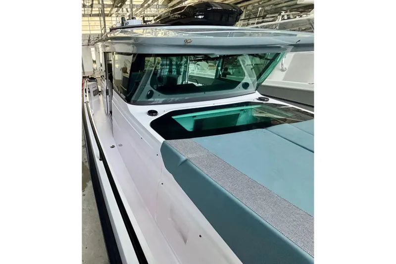 Slide: The Image of 2024 Axopar 37 XC Cross Cabin boat in a showroom, showcasing sleek design and modern features. - 23