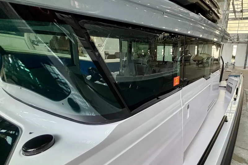 Slide: The Image of 2024 Axopar 37 XC Cross Cabin boat interior view in a showroom setting. - 25