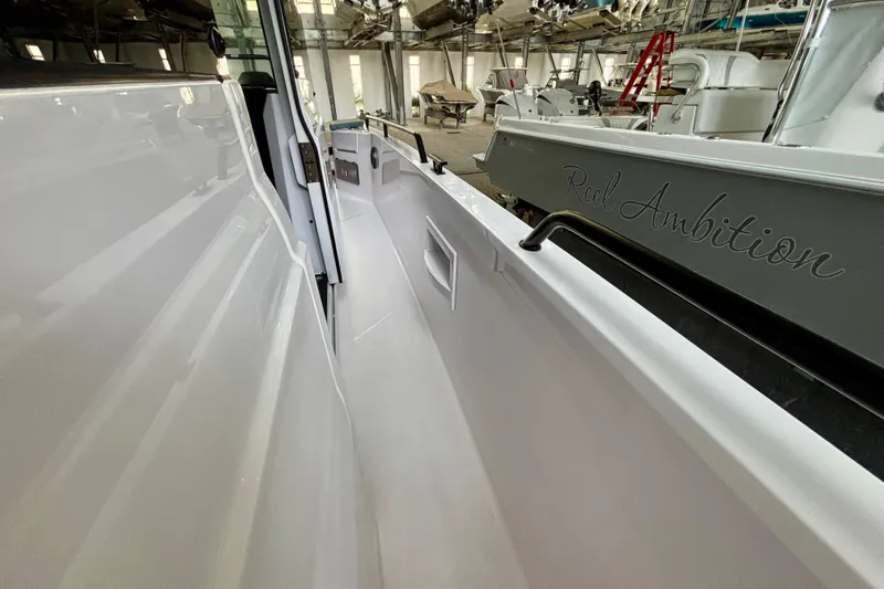 Slide: The Image of Close-up of a black handle on a 2024 Axopar 37 XC Cross Cabin boat. - 27