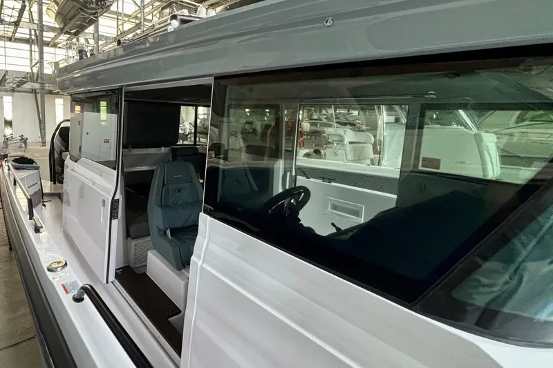 Slide: The Image of 2024 Axopar 37 XC Cross Cabin boat in a showroom, side view. - 29