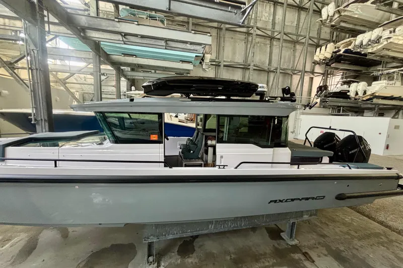 Slide: The Image of 2024 Axopar 37 XC Cross Cabin boat in indoor storage facility. - 3