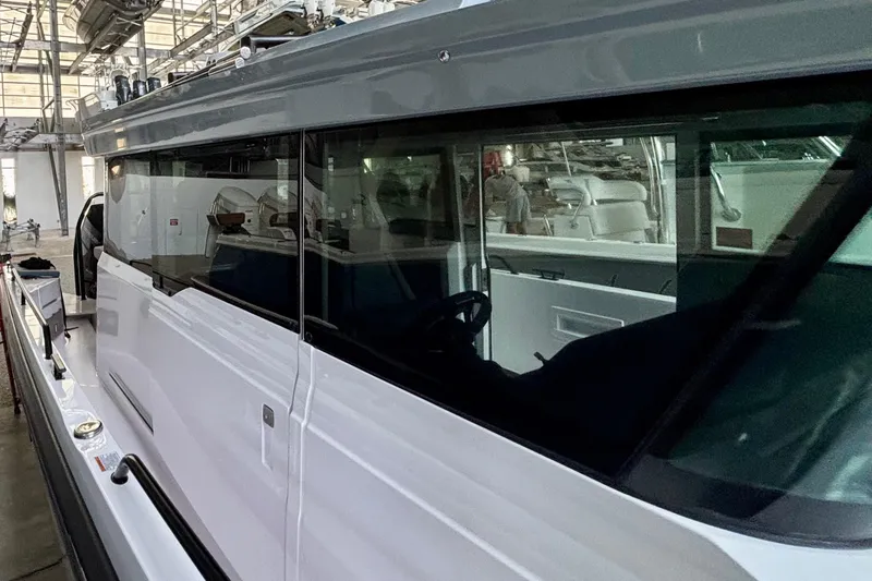 Slide: The Image of 2024 Axopar 37 XC Cross Cabin boat in a showroom, featuring sleek design and modern amenities. - 30
