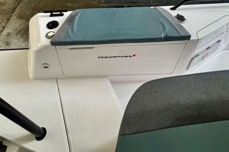 Slide: The Image of 2024 Axopar 37 XC Cross Cabin boat in a showroom, featuring sleek design and spacious deck. - 32