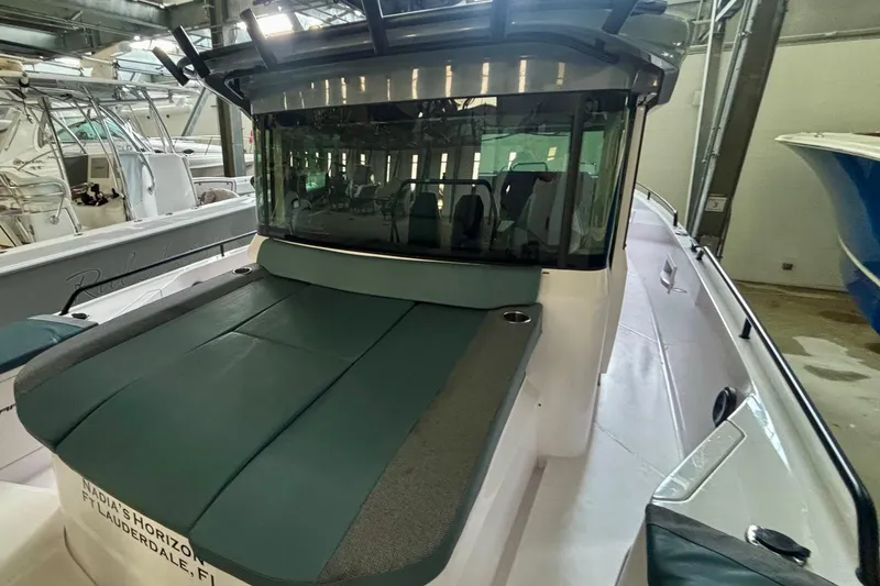 Slide: The Image of 2024 Axopar 37 XC Cross Cabin boat seat with storage compartment. - 33