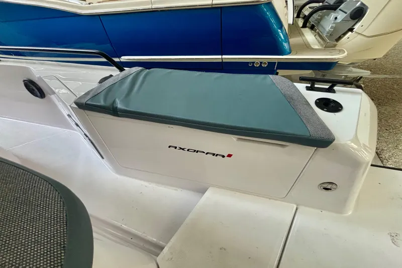 Slide: The Image of 2024 Axopar 37 XC Cross Cabin in a boat storage facility, showcasing its front design. - 34