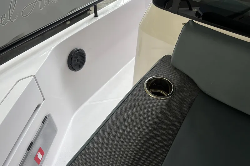 Slide: The Image of 2024 Axopar 37 XC Cross Cabin interior with cup holder and speaker detail. - 38