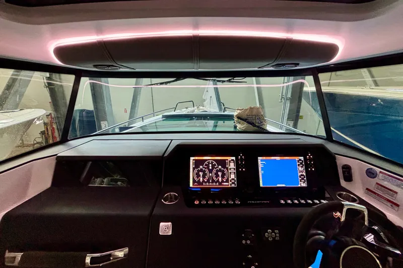 Slide: The Image of Dashboard of 2024 Axopar 37 XC Cross Cabin with digital displays and control buttons. - 42