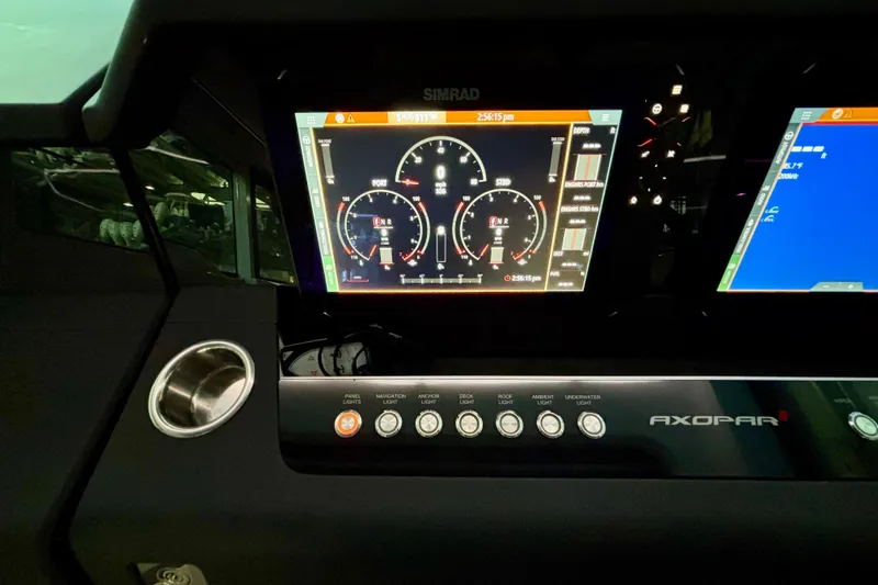 Slide: The Image of 2024 Axopar 37 XC Cross Cabin dashboard with dual Simrad displays and control panel. - 43