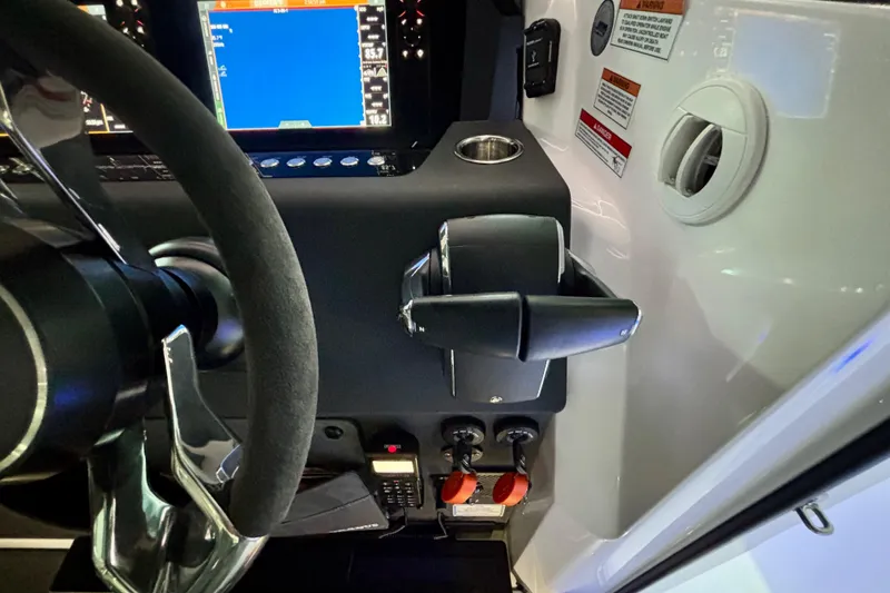 Slide: The Image of 2024 Axopar 37 XC Cross Cabin dashboard with Simrad device and ignition keys. - 47