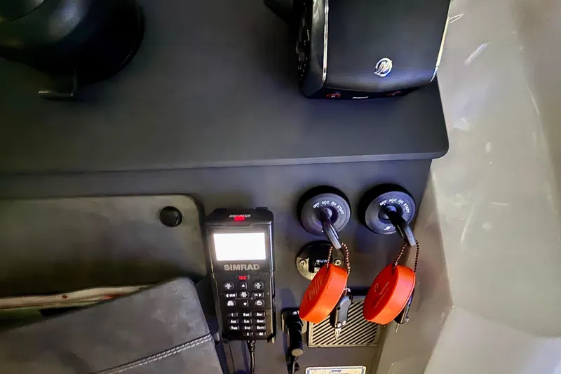 Slide: The Image of Control panel of 2024 Axopar 37 XC Cross Cabin with storage pocket and Simrad device. - 48