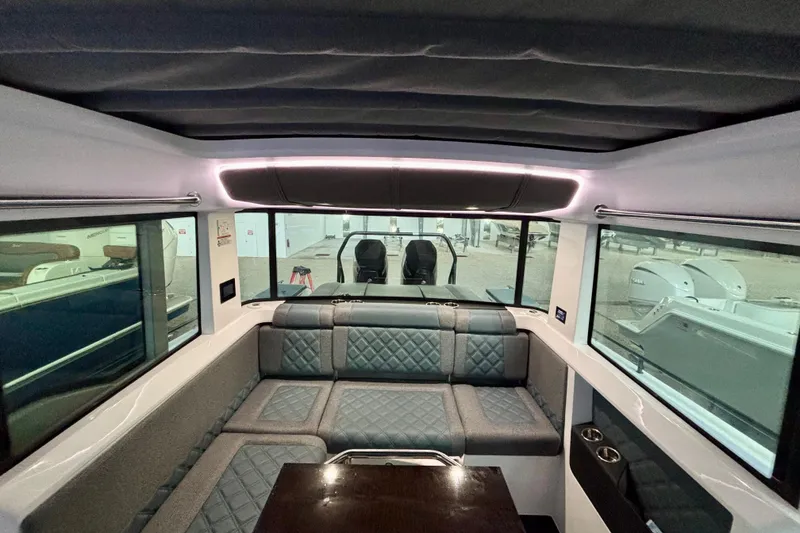 Slide: The Image of Interior of 2024 Axopar 37 XC Cross Cabin, featuring modern seating and large windows. - 53