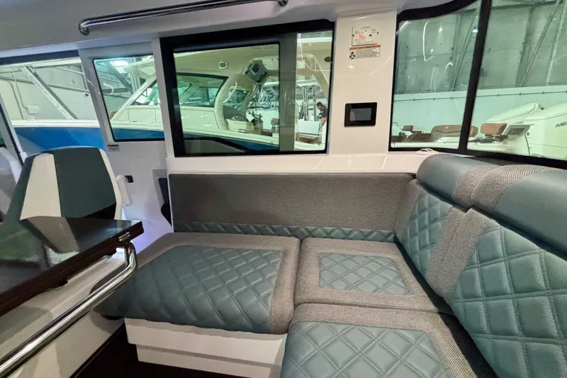 Slide: The Image of 2024 Axopar 37 XC Cross Cabin interior with modern seating and navigation console. - 56