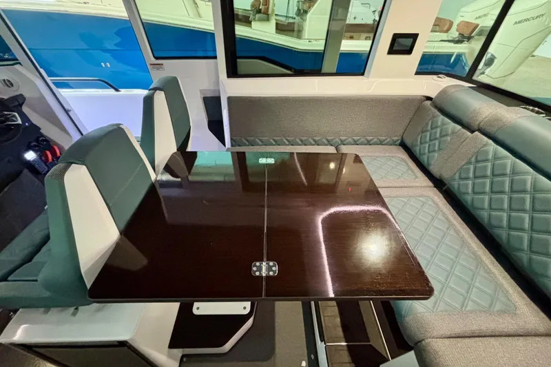 Slide: The Image of 2024 Axopar 37 XC Cross Cabin interior with navigation displays and cabin access. - 58