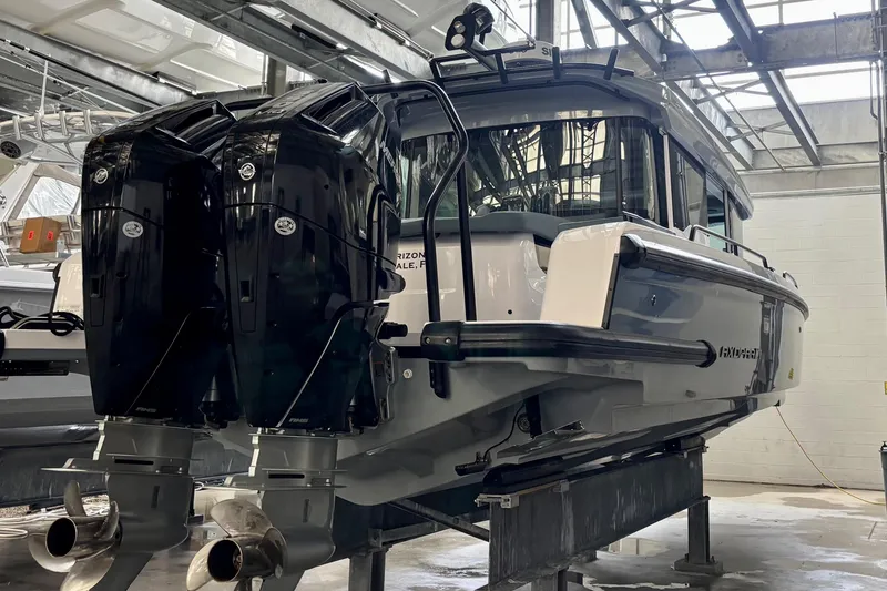 Slide: The Image of 2024 Axopar 37 XC Cross Cabin boat in a marina setting. - 6