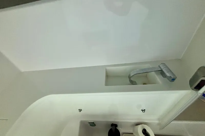 Slide: The Image of 2024 Axopar 37 XC Cross Cabin control panel with switches and knobs. - 62