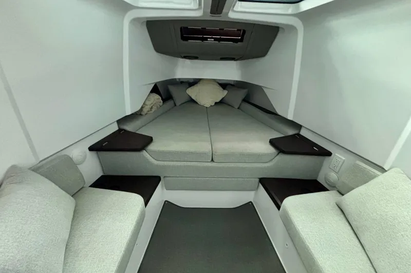 Slide: The Image of 2024 Axopar 37 XC Cross Cabin interior with cozy sleeping area and cushions. - 64