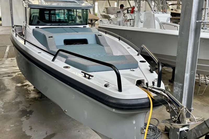 Slide: The Image of 2024 Axopar 37 XC Cross Cabin hull detail in a workshop setting. - 7
