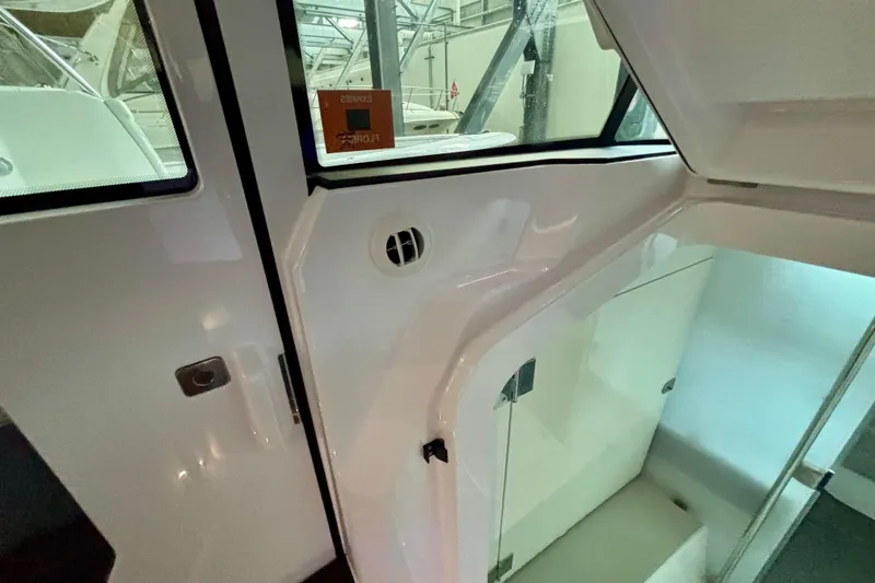 Slide: The Image of Interior of 2024 Axopar 37 XC Cross Cabin with seating and control panel. - 70